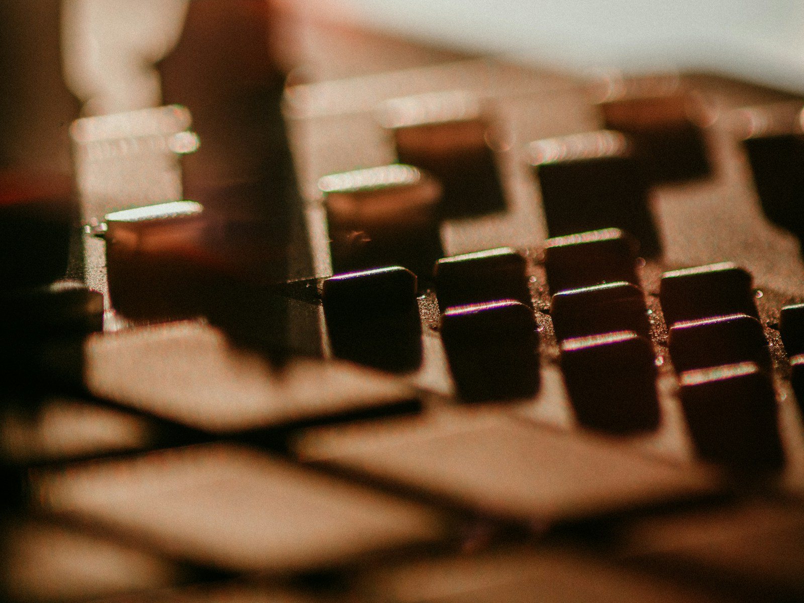 Close-up of a hardware drum machine's tempo display and rubber pads under blue light, no people